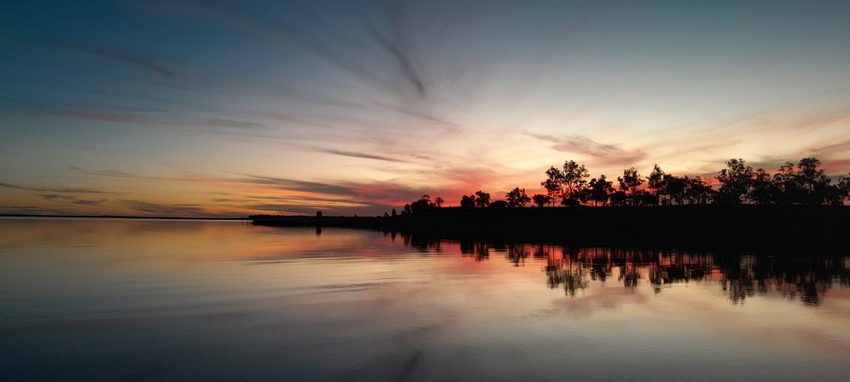Artist capturing North Burnett murals during golden hour.