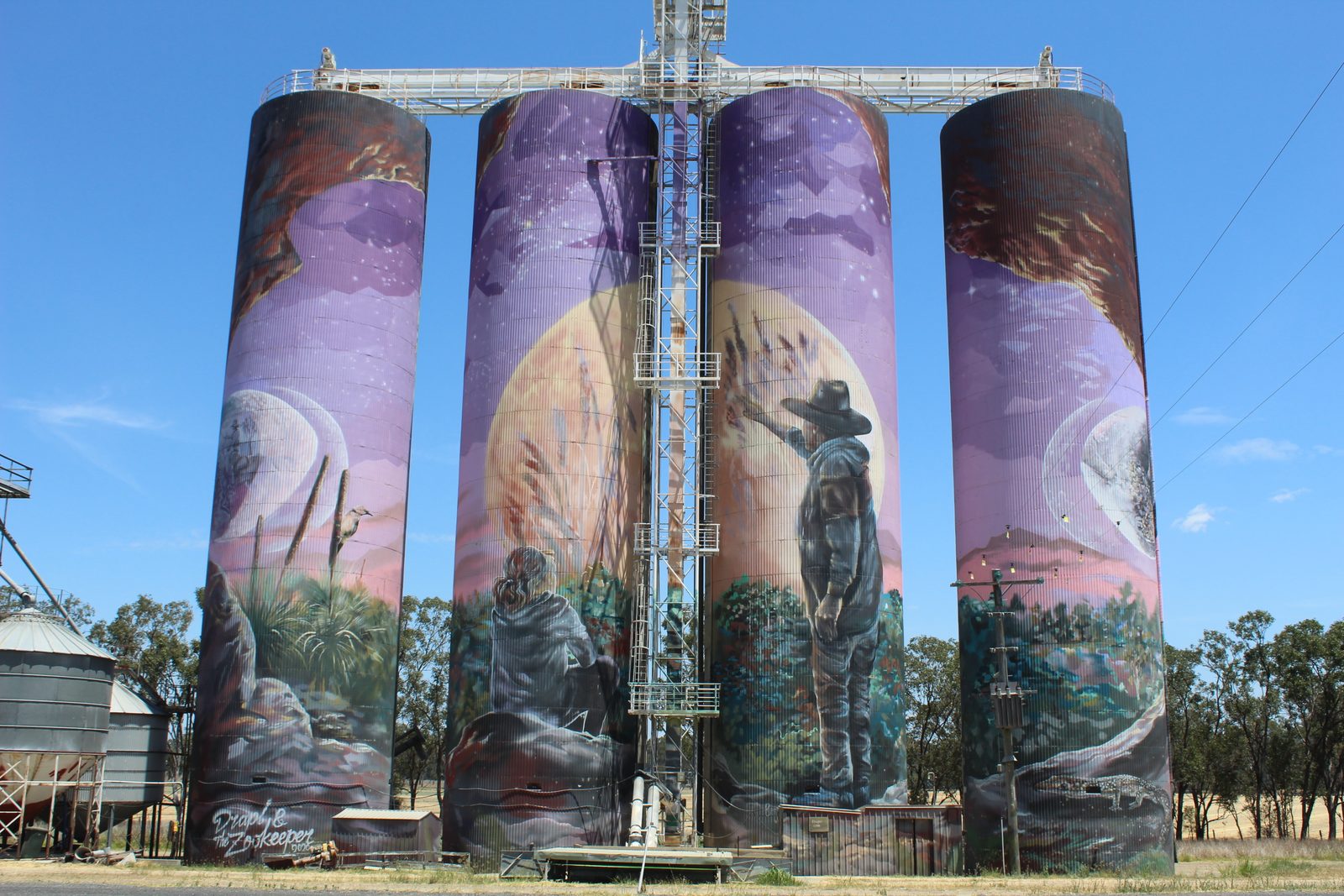 Monto main street murals and heritage streetscape at sunset.